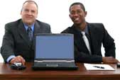 2 Businessesmen with a Computer