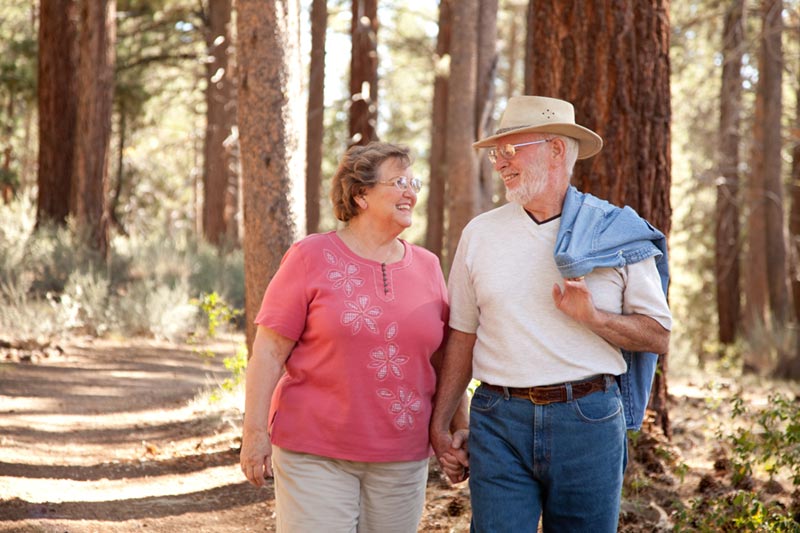 Older couple walking in the woods