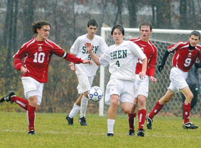 high school socer players play in rainy game