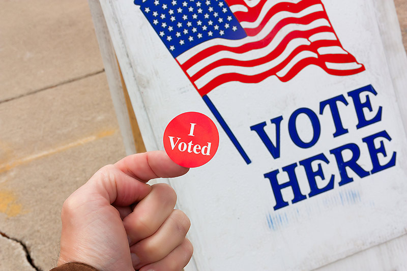 i voted sticker with polling place sign