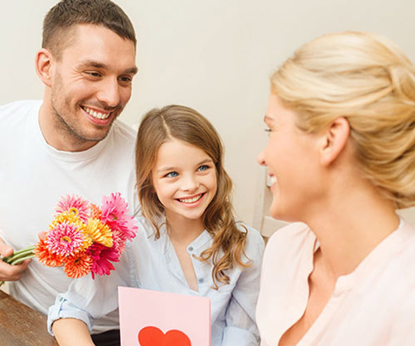 Father and daughter giving gift to mom.