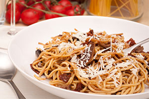 pasta in white bowl covered with cheese