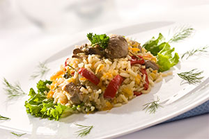 rice with peppers and mushrooms garnished with dill on a white plate